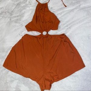 burnt orange romper, halter top & ties in the back & ring detail in the middle